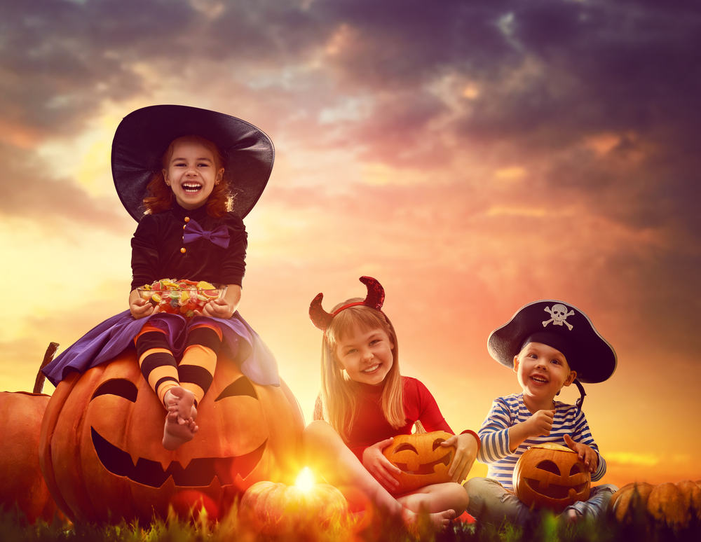 Image of three children getting dressed up and ready for Halloween in Miami.