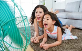 Woman and Daughter lying in front of a fan