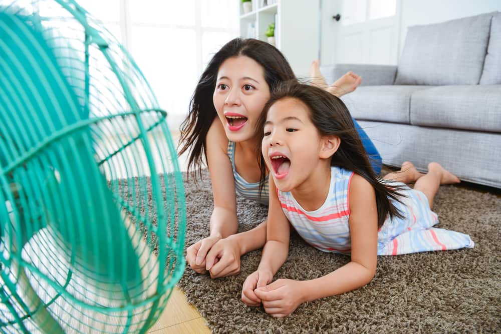 Woman and Daughter lying in front of a fan