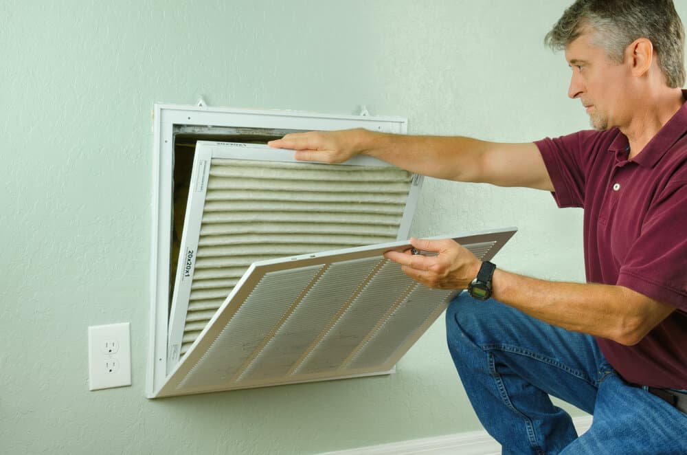 Man Fixing an Air Ventilation