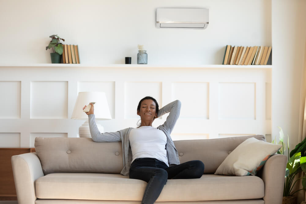 Black Woman sitting on a sofa and relaxing