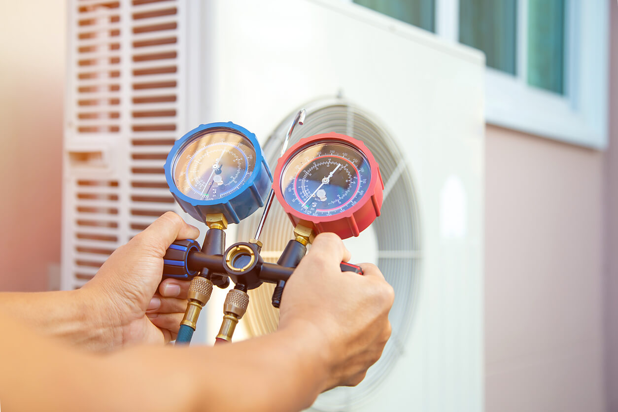 Hands of Technician Are Using a Measuring Tool to Check Vacuum Pump Evacuates Air for Air Conditioner.