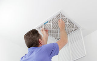 Person Removing Ceiling Air Filter.