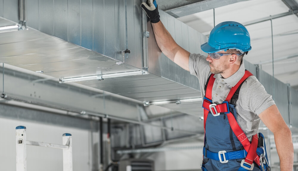 Commercial Warehouse Building Air Circulation System Building Caucasian HVAC Company Supervisor in His 40s Performing Final Ventilation Check